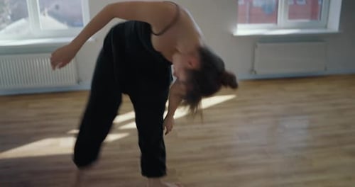 Elegant Woman Dancing in a Bright Studio