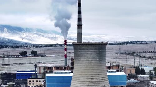 Aerial view of an oil refinery emitting steam and smoke,