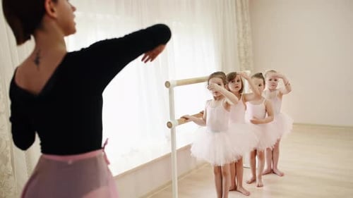 Ballet Instructor teaching Children in Dance Studio