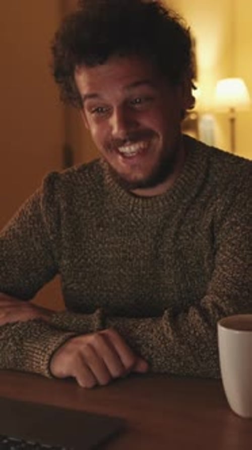Man Smiling During Video Call at Home