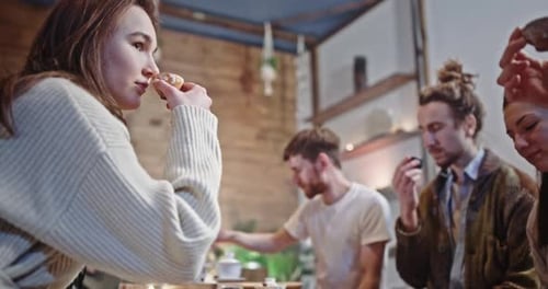 Friends Enjoy Tea and Snacks at Wooden Table