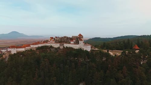 Aerial View of a Beautiful Historic Castle Nestled Amidst Lush Green Forests Below