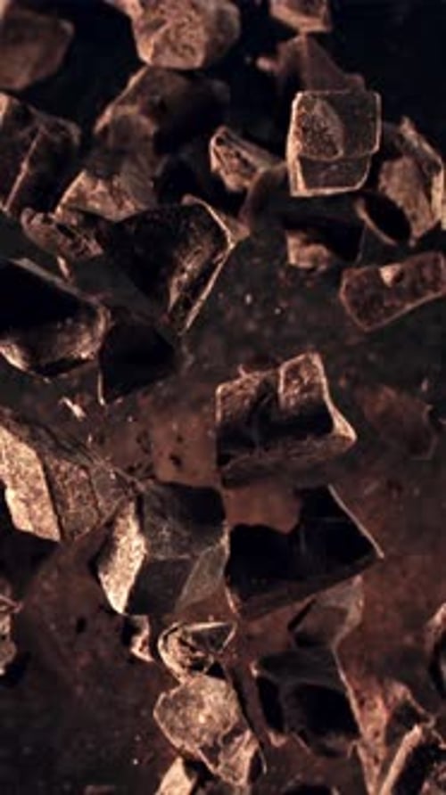 Pieces of Chocolate Take Off and Rotate in Flight Filmed is Slow Motion 1000 Fps