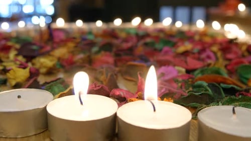 Shot of lighted candles used for prayers in memorial wedding funeral services in a religious church