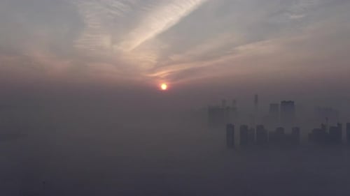 A city that seems to be floating in the air with fog and dust.