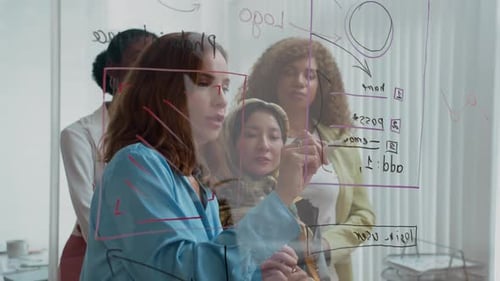 Diverse Colleagues Collaborate on Strategy Using Glass Board