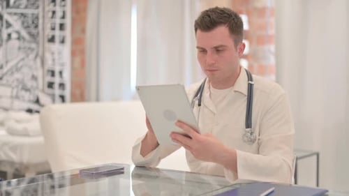 Male Doctor using Tablet in Clinic