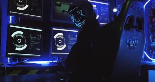 Hacker with Glowing Mask in Dark Cyber Room