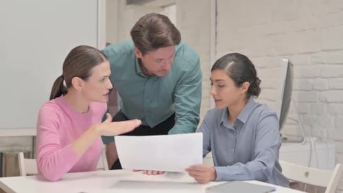 Creative Team Discussing Annual Report in Office