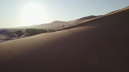 Girl Walking on Top of a Giant Dune in Namibia