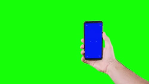Male Hand Holding Smartphone with Blue Screen with Markers on Green Background