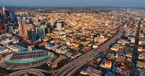 Sunlit scenery of LA downtown at sunset. Aerial perspective on American metropolis