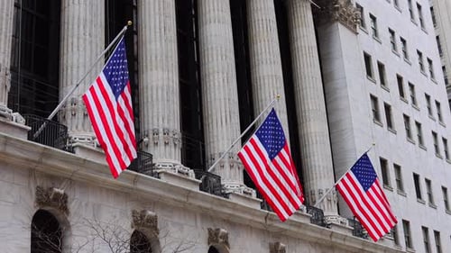 Building with American Flags Waving in the City