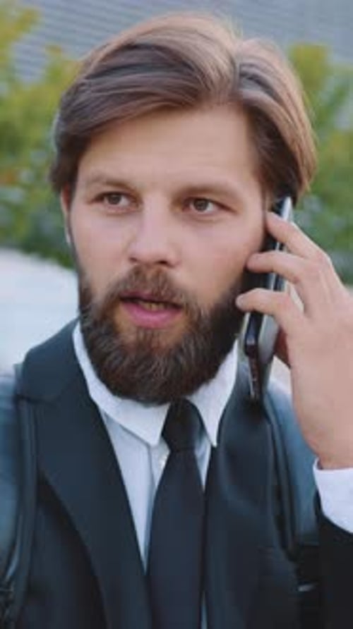 Portrait of Man Office Worker with Wellmaintained Beard in Business Clothes Which Talking on Mobile