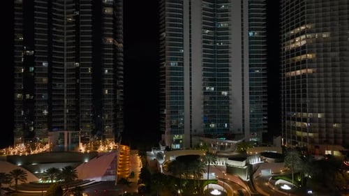 View From Above of Brightly Illuminated High Skyscraper Buildings in Downtown District of Sunny