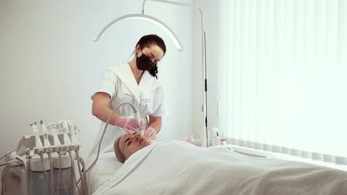 Woman Receives Facial Treatment in Clinic