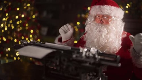 Santa Typing on Typewriter by Christmas Tree