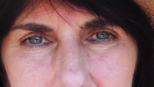 Close Up to Upset Female Face Looking Into Camera with a Disappointing Sight Upset Facial Expression