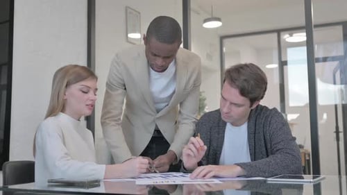 Mixed Race Entrepreneurs Discussing Work in Office