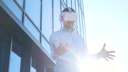 Portrait of an Office Worker Wearing VR Glasses Moving His Hands in the Air