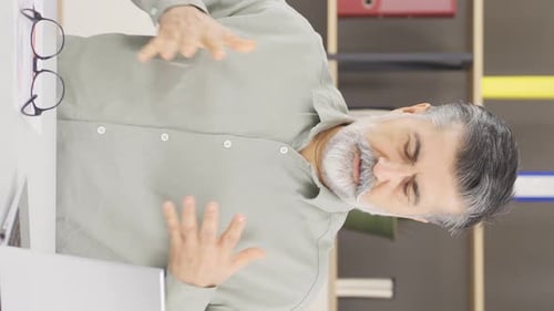 Vertical video of Company manager angry at the phone.