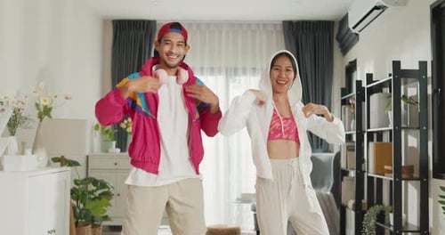 Energetic Couple Dancing Joyfully Indoors