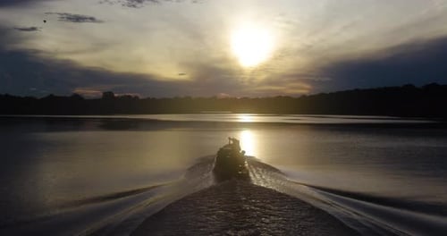 boat at sunset in amazonas river