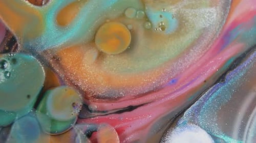 Close-up of swirling colors from ink mixing with water, vibrant and abstract