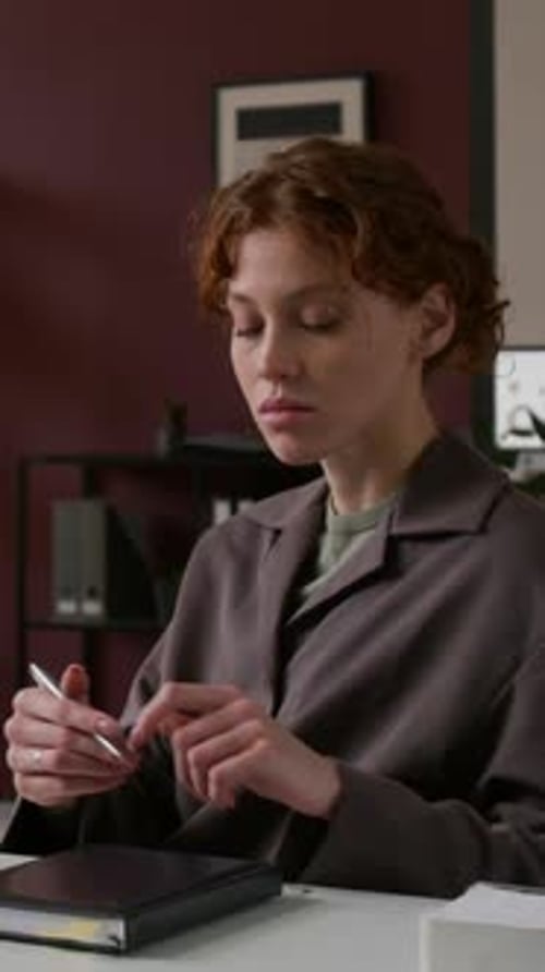 Businesswoman Working on Laptop And Making Notes