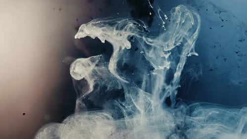 Slow motion shot of black and blue paint ink exploding blast underwater,close up