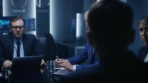 Business Professionals Meeting in Dark Corporate Office