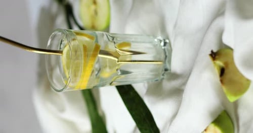 Refreshing Lemon Water with Golden Straw, Apple Slices