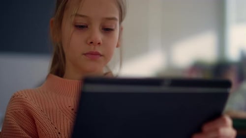 Focused Girl Getting Education with Tablet Computer in School. Closeup of Diligent