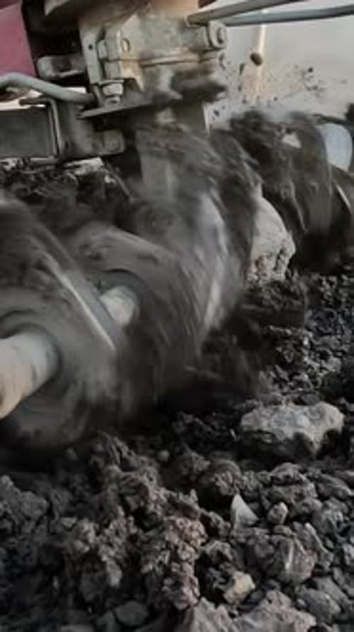 This Farmer is Plowing the Ground with a Tiller Block and Using a Motor Cultivator in the Garden to