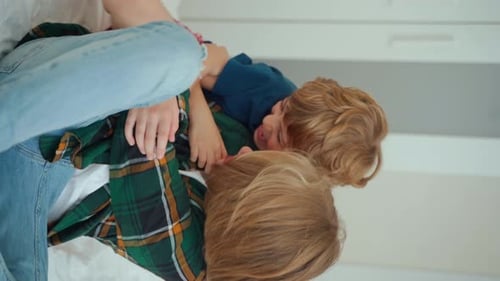 Children Playfully Wrestling in a Home