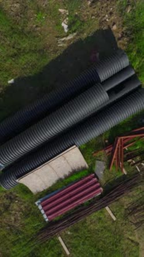 Vertical Video of Workers Laying Foundations and Engineers Checking Plans on a Construction Site