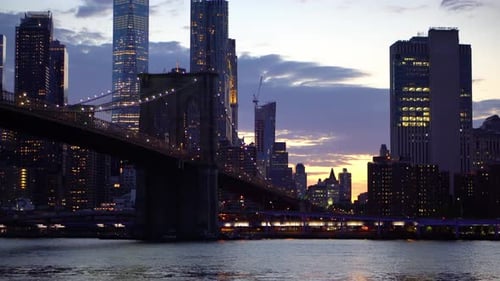 Brooklyn bridge at night with skyscrapers