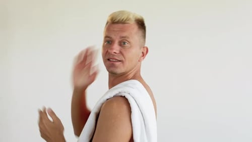 Shirtless Man with Towel Rubbing Face Smiling