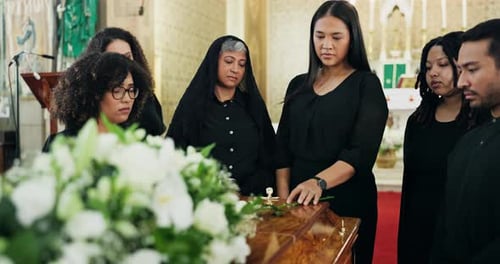 Funeral, church or family by coffin with flowers at memorial service for respect