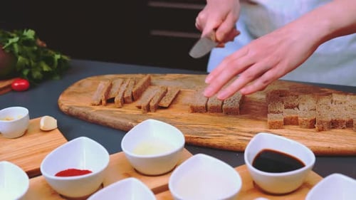 Cut Rye Bread Into Croutons on a Cutting Board
