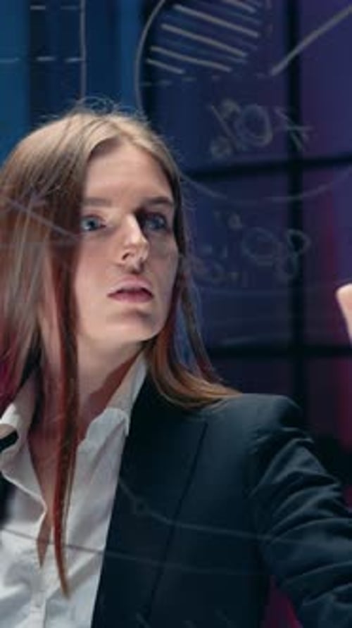 Woman Writes on Glass Wall in Office Building