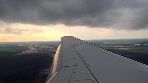 Airplane Wing Frames View of Ground Below As Commercial Aircraft Whether It Family Embarking on