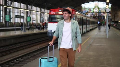 Man Pulls Suitcase in Modern Train Station