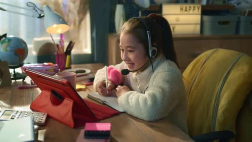 Girl Engaged in Online Education on Tablet at Desk