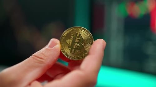 Close-up of Bitcoin Being Held