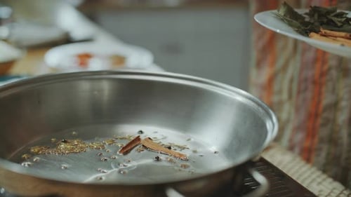 Cooking Spices Being Put into a Pan