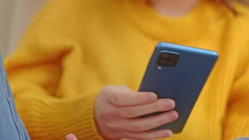 Close-Up Of A Woman Relaxing And Using Her Smartphone