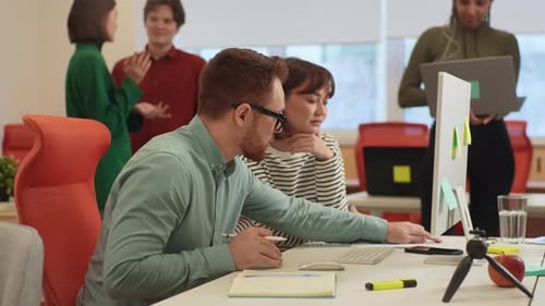 Diverse Team Collaborating on Computer in Modern Office