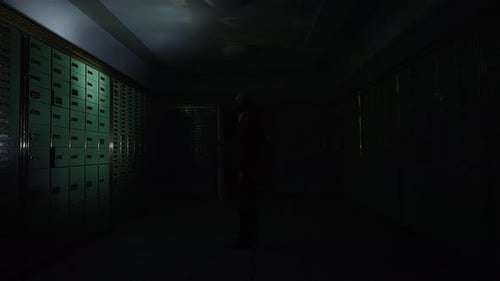 Man with Flashlight Walks Through Dark Hallway