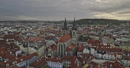 Prague Czechia Aerial v110 flyover in between spires of Church of Our Lady before Týn, tilt down at